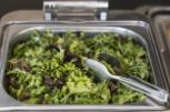 Salad tongues in a serving tray of lettuce